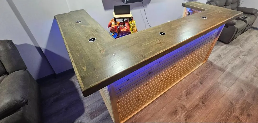 L-shaped bar with dark stained top and blue LED lighting